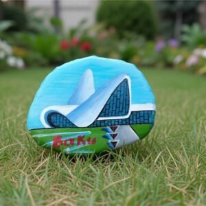 A detailed handcrafted miniature painting of the Heydar Aliyev Center in Baku, applied with fine brushes onto a rugged piece of local Azerbaijani slate stone, by Artirs Family Craft.