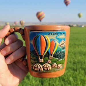 handcrafted ceramic mug with hot air balloon & ancient village relief art. Gilchi Ceramics.