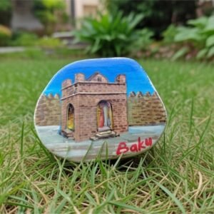 Hand-painted Ateshgah Fire Temple on a smooth natural river stone magnet with a red Baku inscription, made by Artirs Family Craft.